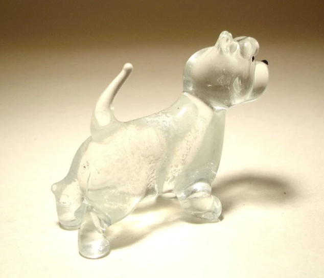 The glass West Highland Terrier figurine is displayed from a side angle, emphasizing the terrier’s strong stance, short legs, and curved up tail.