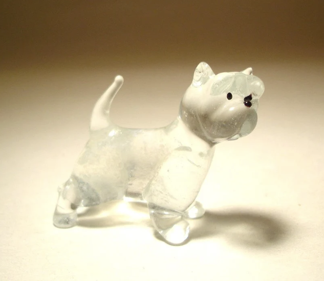 A handcrafted standing glass West Highland Terrier figurine in clear glass.