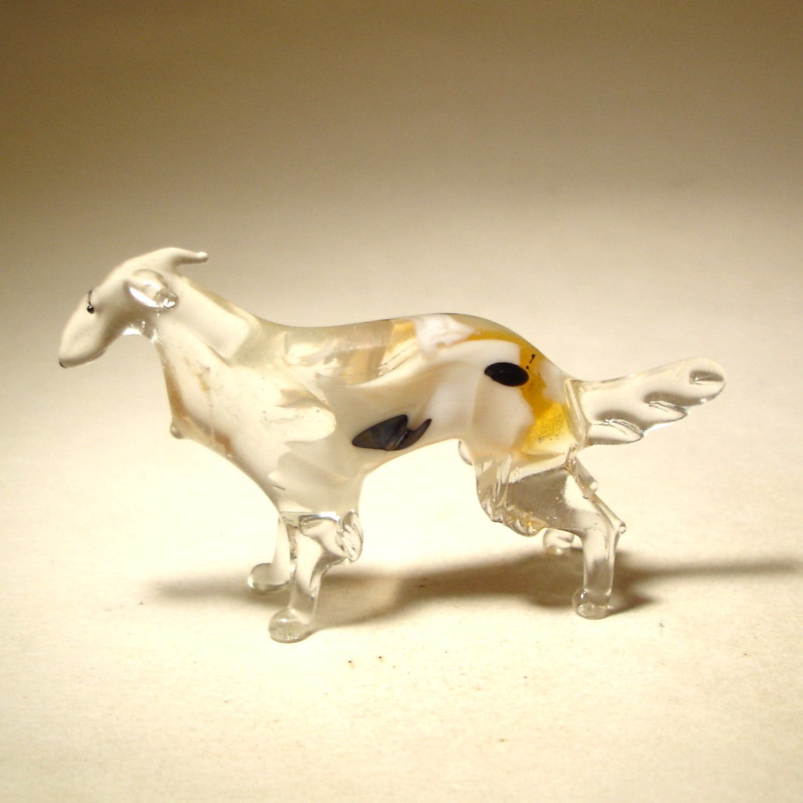 Side view of the glass Borzoi figurine, highlighting its slender build and intricately crafted to emphasize the breed's beauty.