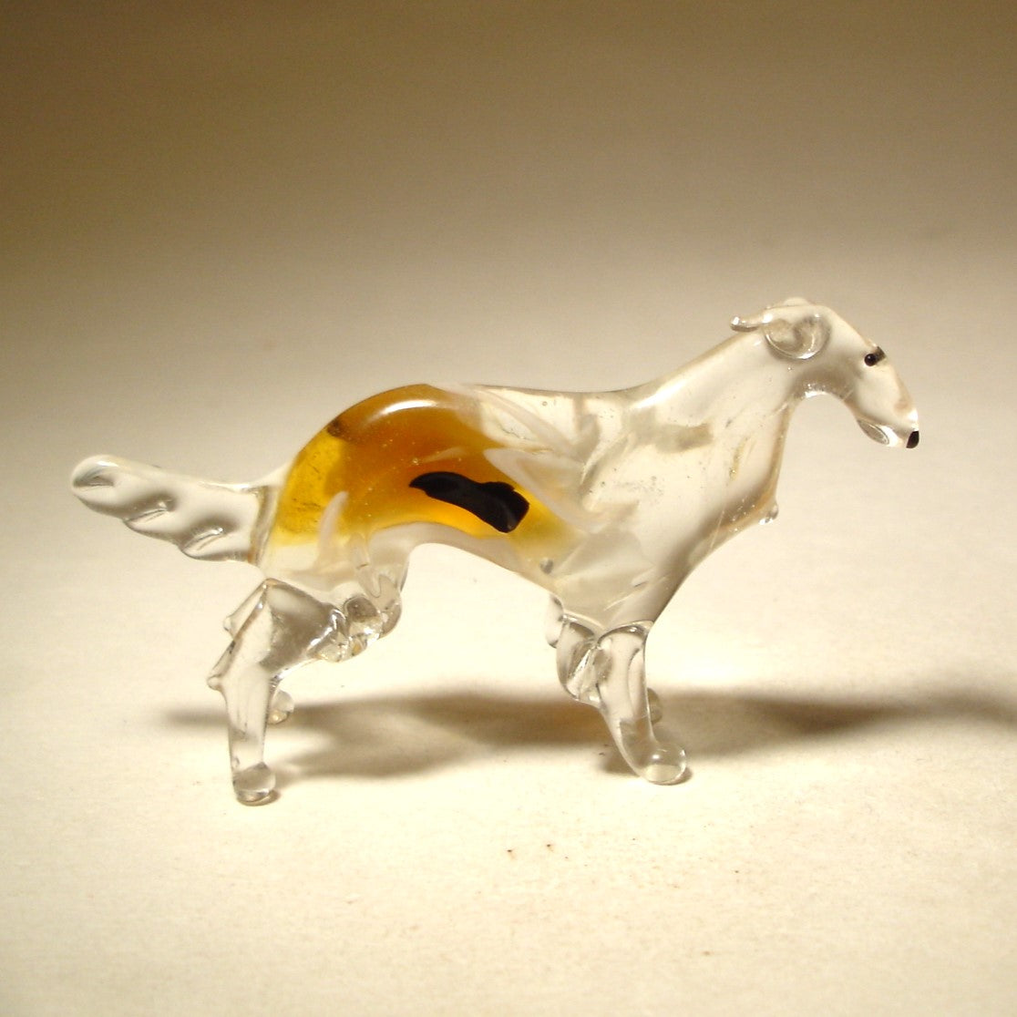 Elegant glass Borzoi figurine in a standing pose, showcasing its graceful long neck and flowing white with brown coat.