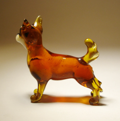 Side profile of the glass Chihuahua figurine, highlighting its delicate legs and smooth coat.