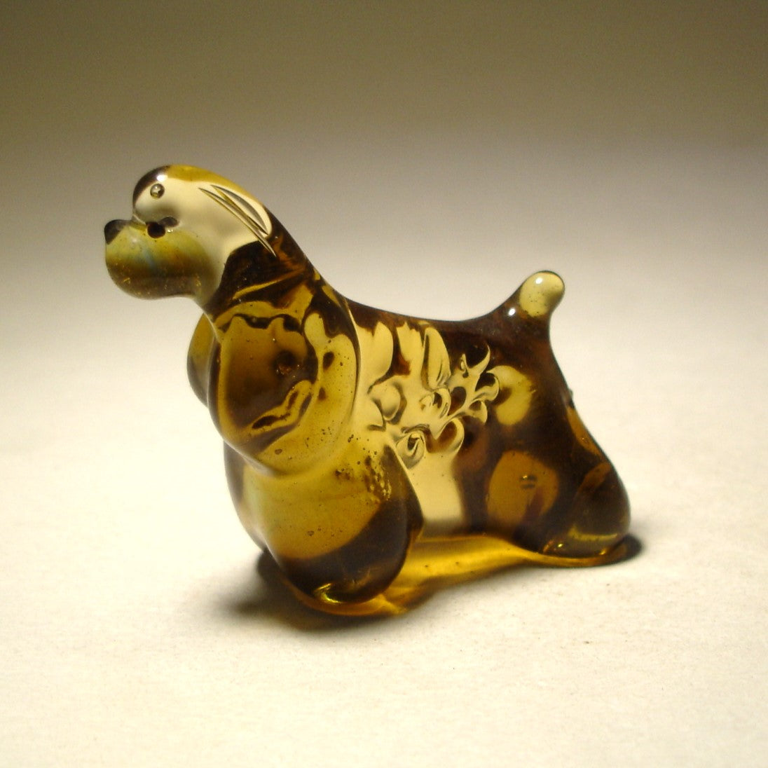 Side view of the glass Cocker Spaniel figurine, displaying its well-proportioned body and fluffy fur.