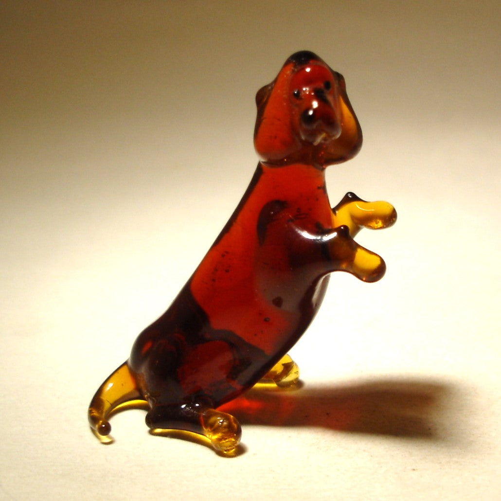 Brown glass dachshund figurine sitting on back legs