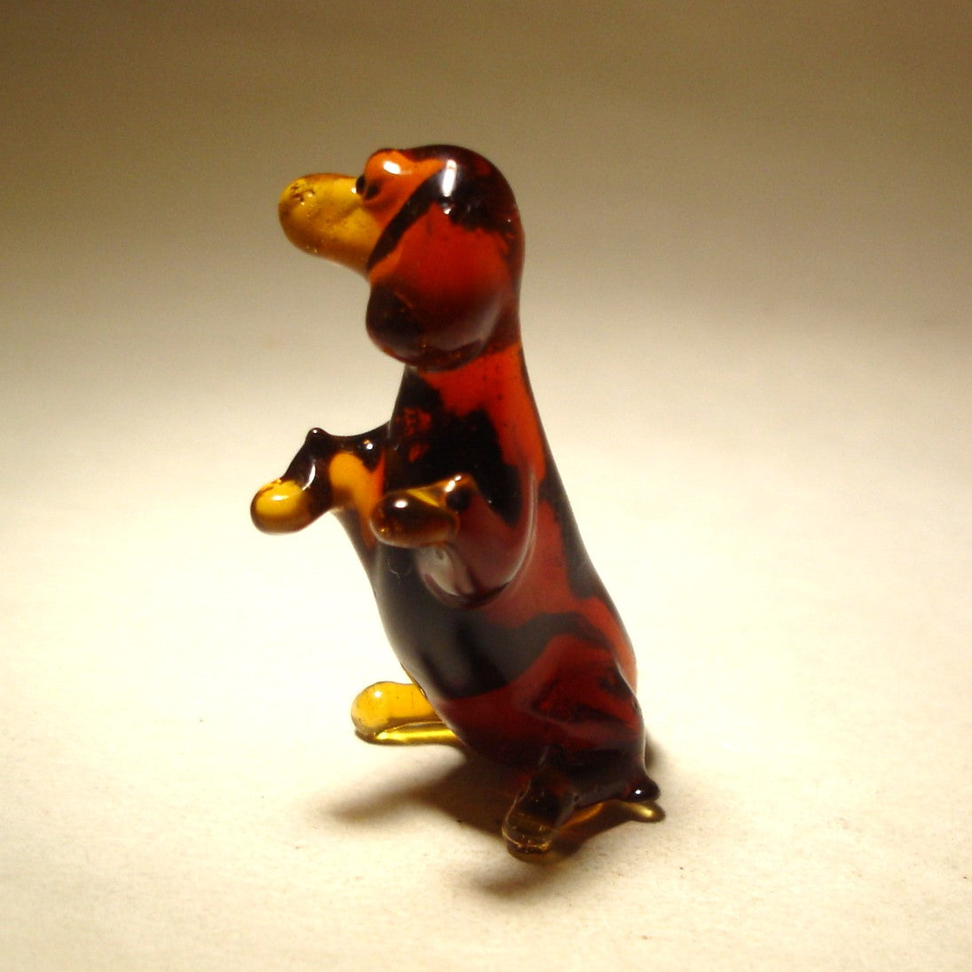 Close-up of the glass Dachshund figurine’s face, capturing its expressive eyes and drooping ears.