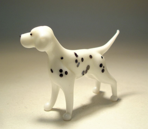 Side view of the glass Dalmatian figurine, showcasing its smooth, spotted coat and poised stance.