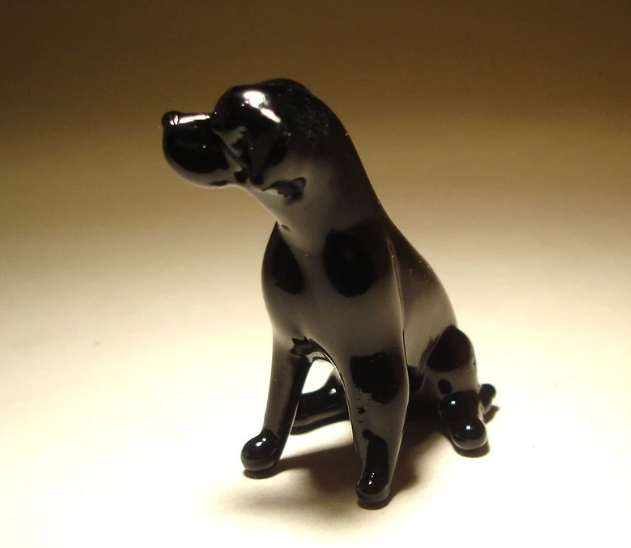 Handcrafted glass Black Labrador figurine sitting alert, showcasing its sleek body and glossy black finish