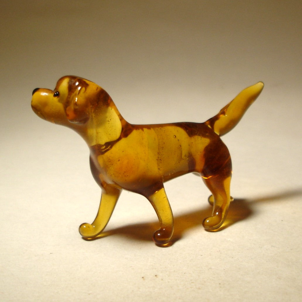 A handcrafted glass Yellow Labrador Retriever figurine stands gracefully, featuring the breed's smooth yellow coat and friendly expression.