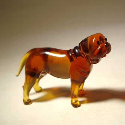 A detailed glass Mastiff figurine captured in a standing pose, showcasing its muscular build and distinctive wrinkled face.