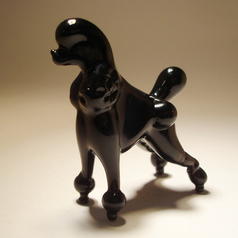 A delightful glass Poodle figurine in a standing pose, showcasing its elegant classical A delightful glass Poodle figurine in a standing pose, showcasing its  elegant traditional haircut.