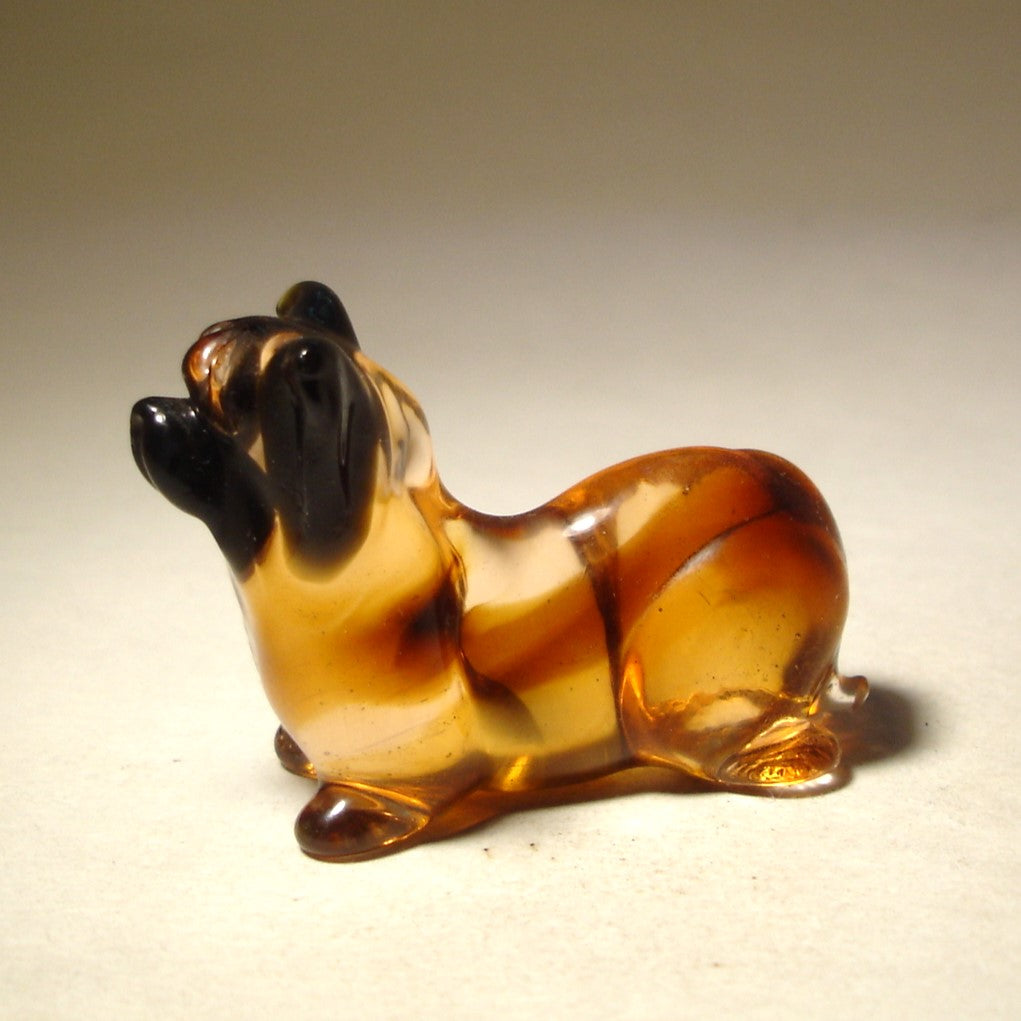 Left side view of the brown-beige glass Skye Terrier figurine with black nose and ears.