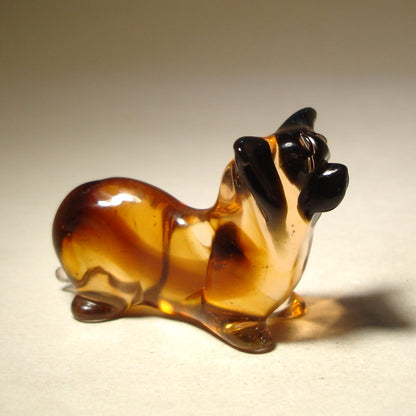 A beautifully crafted glass figurine of a Skye Terrier, featuring its long, flowing fur and distinctive facial features.