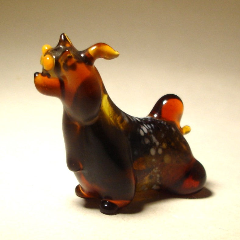 A handcrafted glass Yorkshire Terrier figurine stands proudly, with intricate details capturing the breed's silky coat and alert stance.