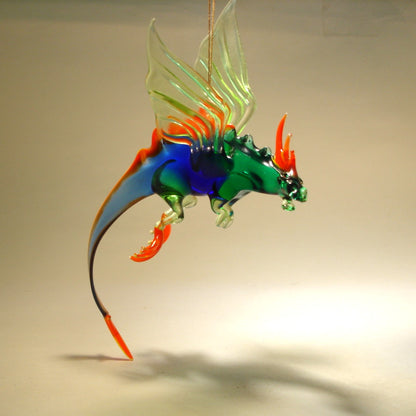 A side view of the glass dragon figurine, emphasizing the detailed design of the wings and the long, coiling tail. 

