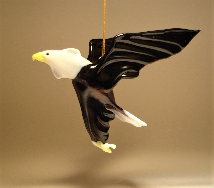 Handmade glass eagle ornament showing its sharp beak and eye features.