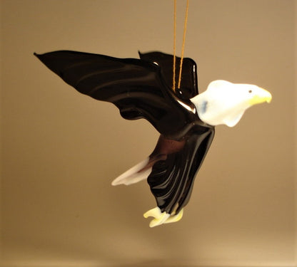 A striking glass hanging eagle figurine ornament showcasing intricate details of feathers.