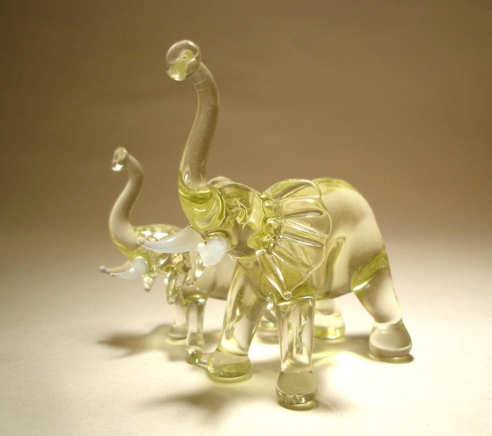 Side view of the glass elephants with a mother on the front.