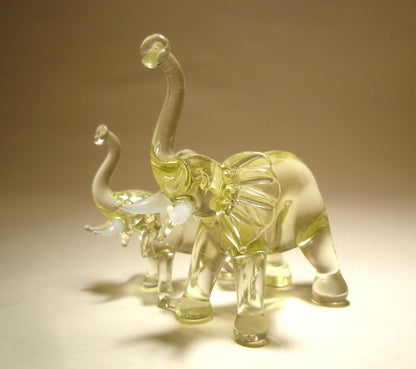 Side view of the glass elephants with a mother on the front.