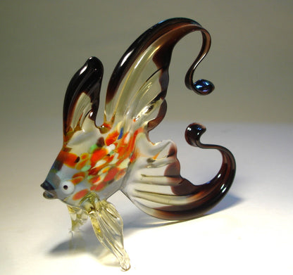 Top view of the black and clear glass fish figurine, showing the intricate coloring on its body and the elegant arch of its tail