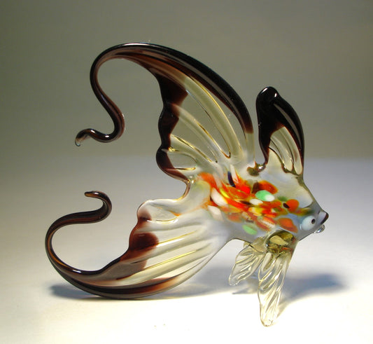 handmade black and clear glass fish figurine with a colorful body, showcasing its arched tail - right side view