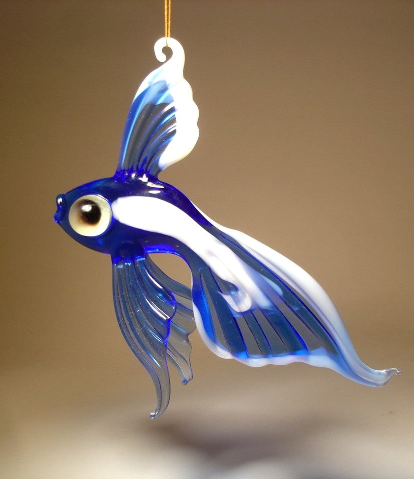 a left side view of handmade blue and white glass hanging telescope fish ornament, showcasing its bulging eyes and flowing fins