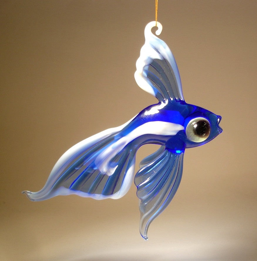 Side view of the blue and white glass telescope fish ornament, suspended on a thread