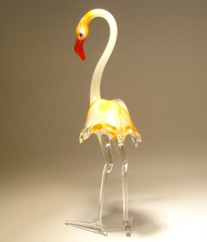 A close-up of the glass flamingo figurine, highlighting the delicate curves of its neck and intricate feathers.