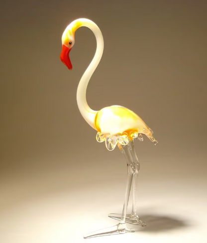 A beautifully crafted glass flamingo figurine standing firmly on both legs. 