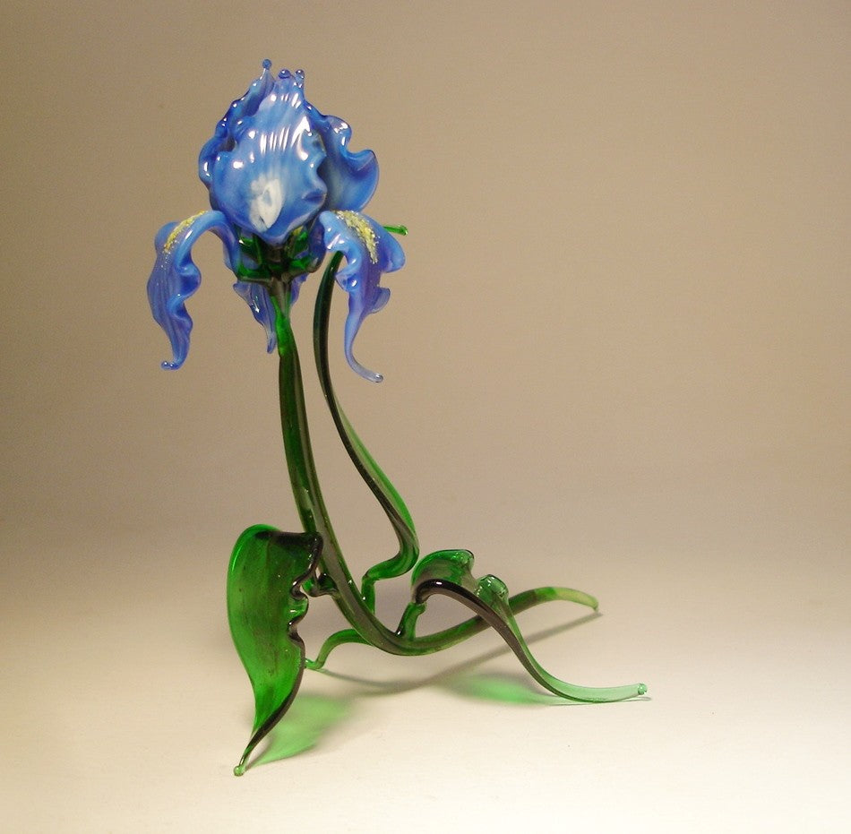 Another side view of the glass blue iris flower figurine, focusing on the fine craftsmanship of the petals, leaves, and stem.