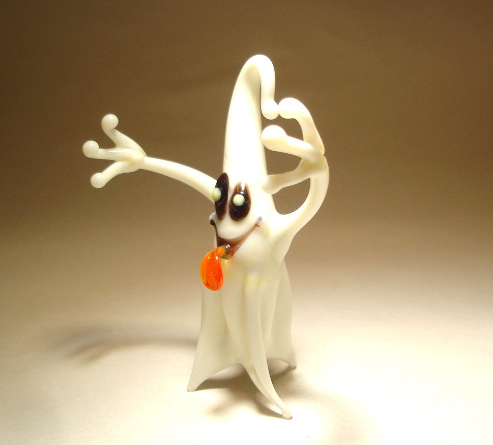 Close-up of the glass white ghost figurine with a red tongue out  showcasing playful expression.