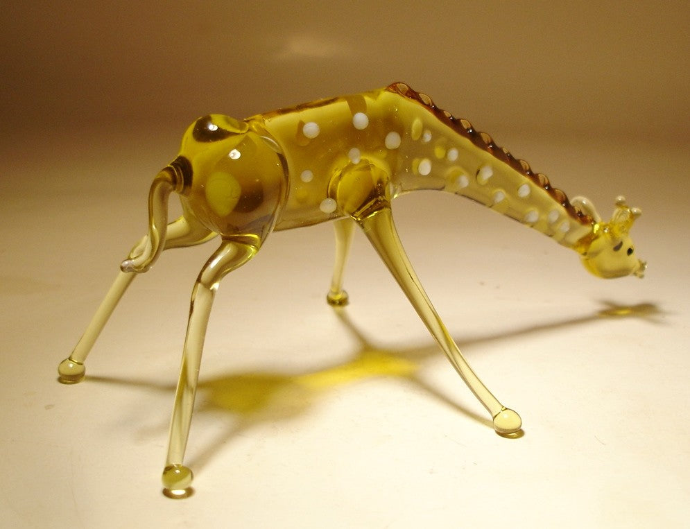 Side view of the drinking water glass giraffe figurine, highlighting its elegant posture.