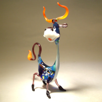 Side view of the Glass Happy Cow Figurine standing on its legs, highlighting its playful pose and curved tail.