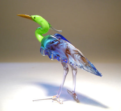 A back view of the glass heron figurine highlighting its blue back and intricate feathers on the side of its body.