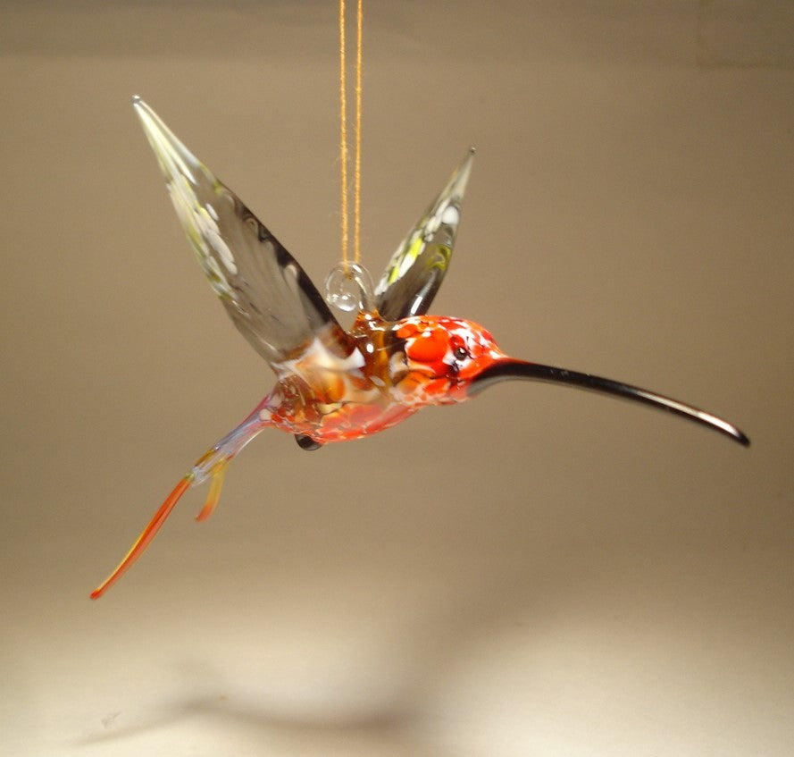 Front view of the swallowtail hummingbird ornament showing the long black beak and a glass hanging hook.