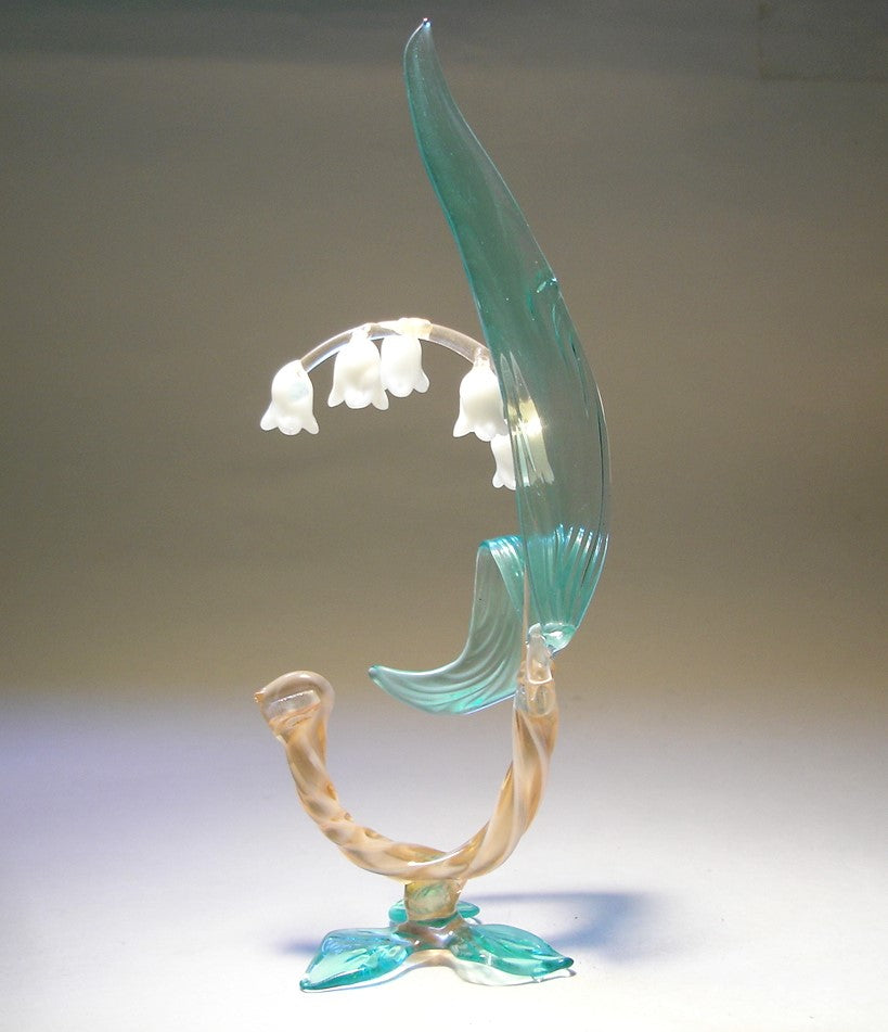 A side view of the glass Lily of the Valley flower figurine, capturing its graceful curves and the arrangement of flowers along the stem.