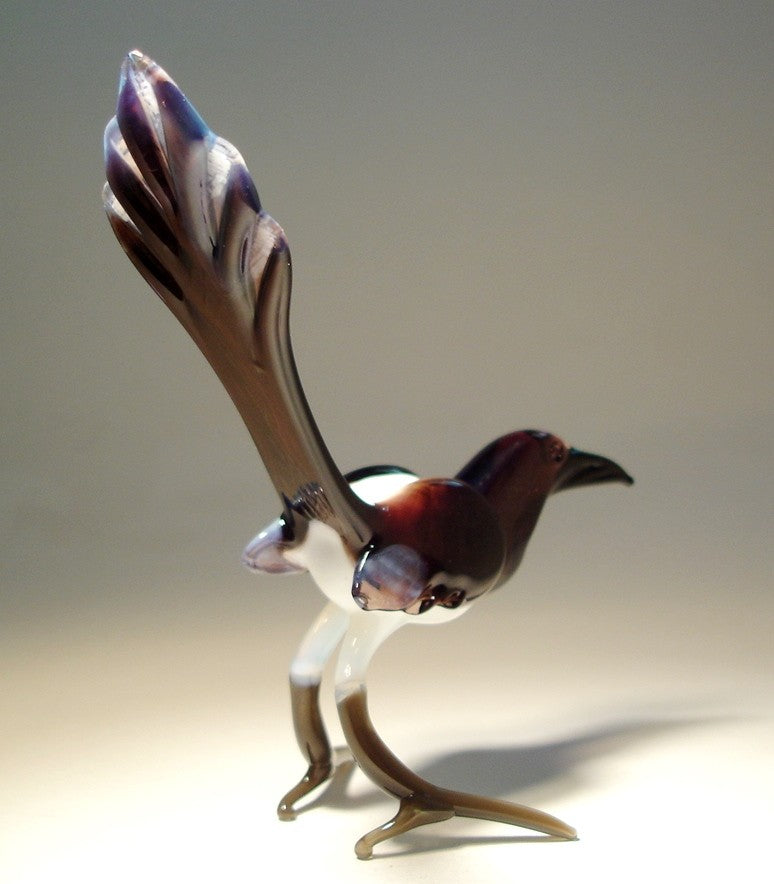 Back view of the glass magpie figurine, showcasing its glossy black and white feathers with a polished finish.