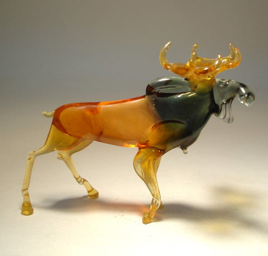 Side view of the glass moose figurine, showcasing its strong stance and elegant curves.