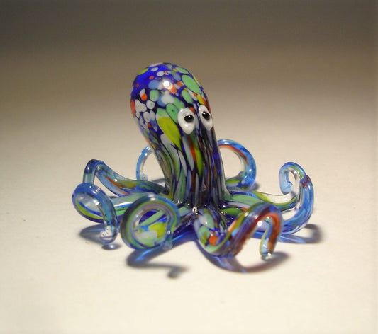 blue octopus figurine with multiple colorful specs all over the body and tentacles