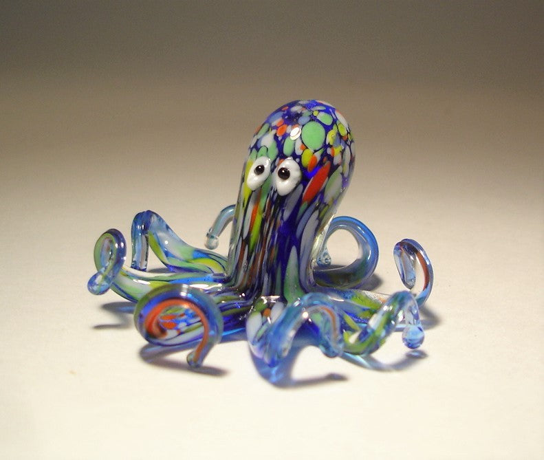 front view of the blue glass octopus featuring two black on white eyes