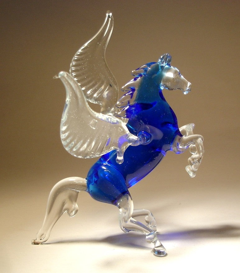 Side view of the blue glass Pegasus figurine, highlighting the detailed wings and graceful stance