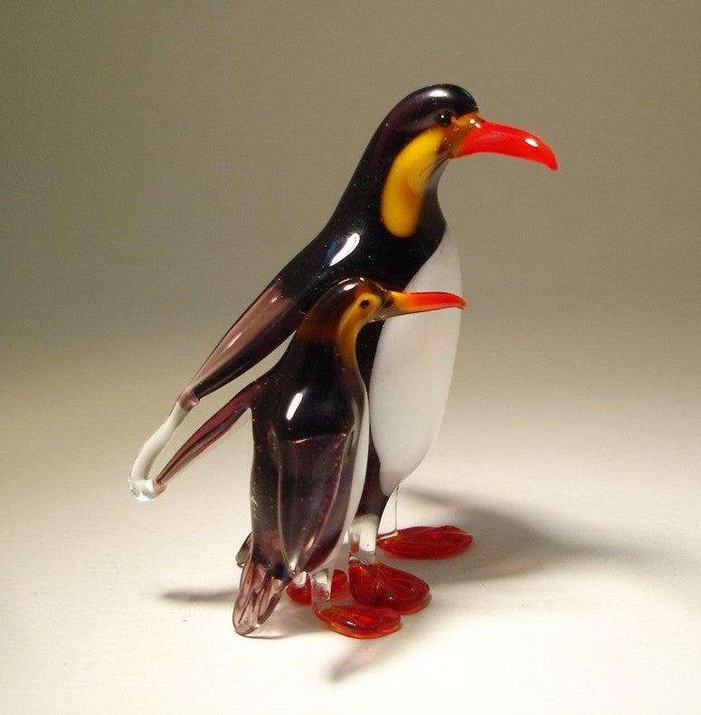 Side view of the glass penguin with its baby, showcasing the proud stance of the adult penguin and the small, adorable baby.