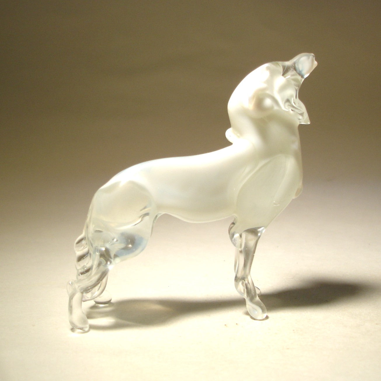 A top-down perspective of the glass polar wolf figurine, showcasing its elegant posture. 