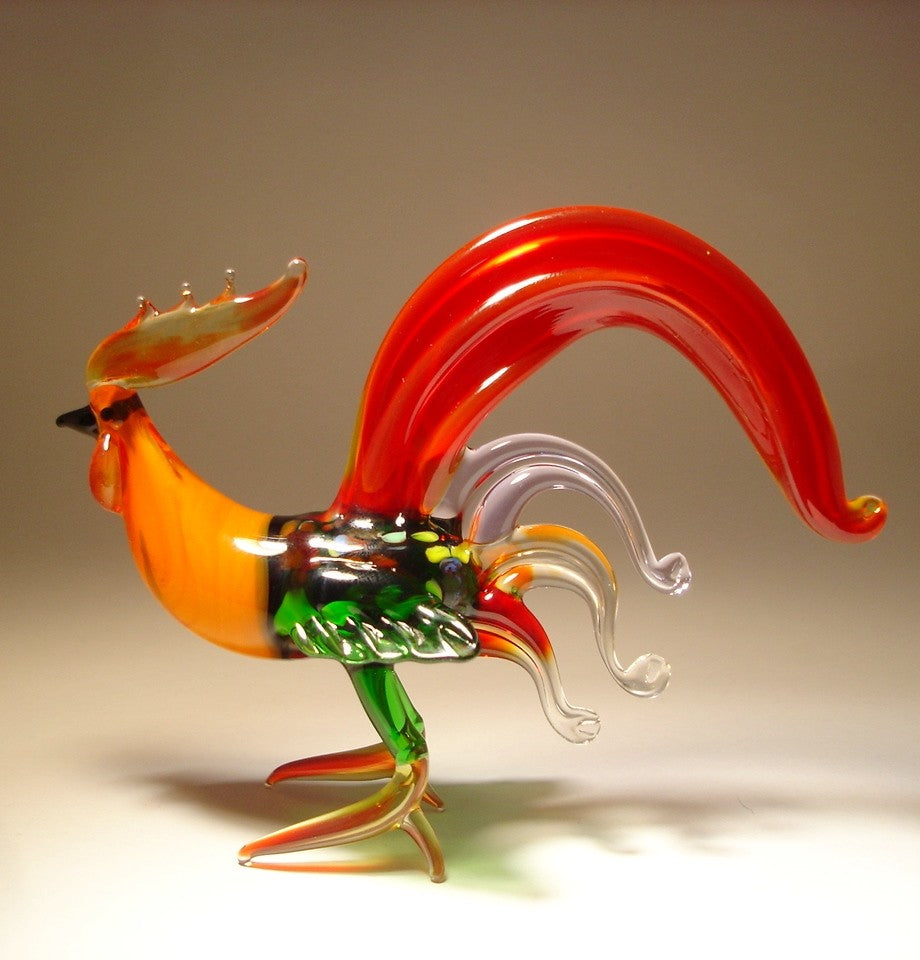 Another side view of a glass red fighter rooster, highlighting its muscular build, intricately crafted feathers, and flowing tail.