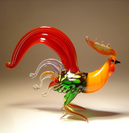 A side view of a glass red fighter rooster, showcasing its detailed beak, vibrant red plumage, and a proud stance.