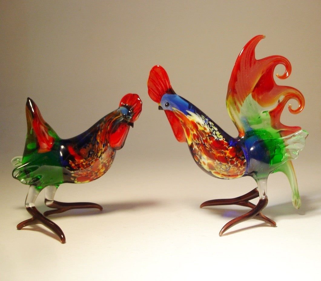 The glass and hen rooster figurines with matching red, green and blue colors