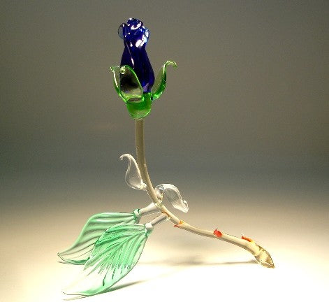 glass dark blue rosebud figurine resting on two green leaves with a curved stem