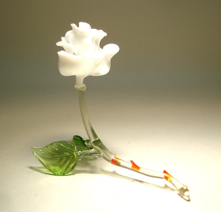 Handmade glass figurine of a white glass rose with red thorns.