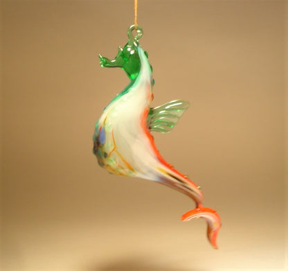 The hanging seahorse ornament is shown from a different view with its red and white its curved tail.