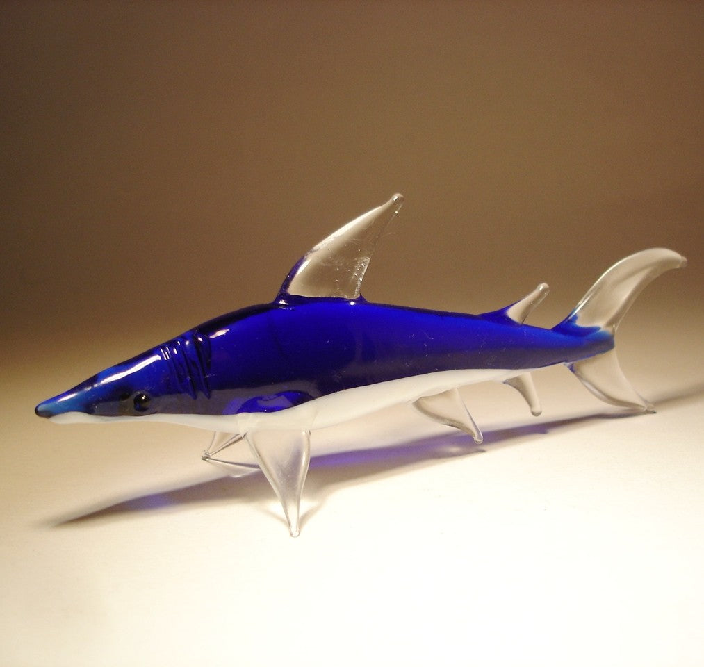 Side view of the glass reef shark figurine, showcasing its details on the fins and gills.