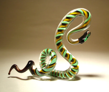 Handmade glass snake with a serpentine like green-black and yellow pattern.