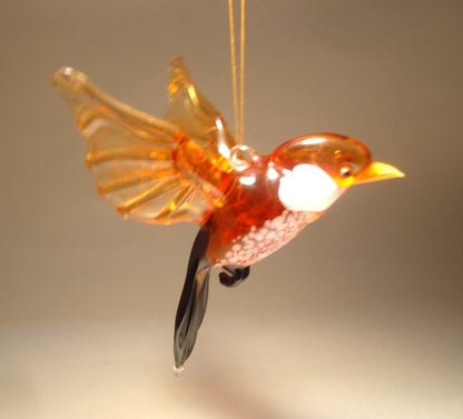 Another side view of a glass sparrow ornament figurine, emphasizing the smooth curves of its body and the detailed tail feathers.